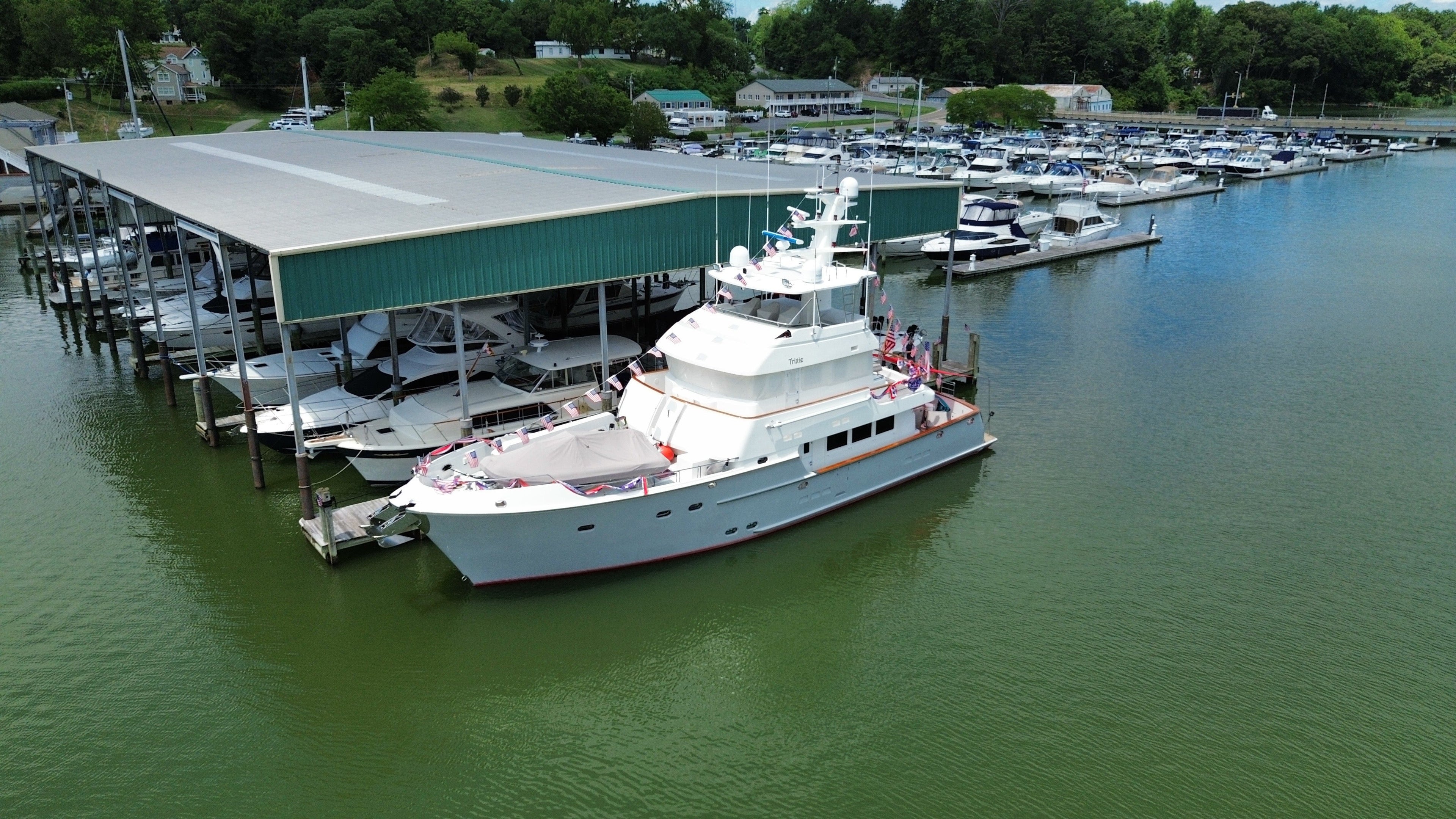 Nordhavn 76 motor yacht Trixie docked at a Chesapeake Bay marina before a Victron MultiPlus-II inverter/charger and Cerbo GX monitoring upgrade by Marine Electric Systems
